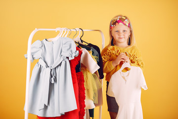 Child with shopping bags. Lady in a yellow sweater. Little designer