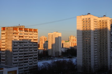 Obraz premium Moscow district of Konkovo, multi-storey residential buildings at winter evening with shadows from sun light