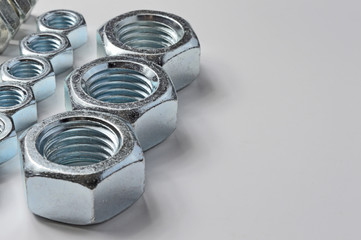 Big and small screw-nut. Concept. White background.