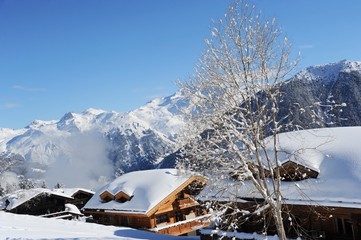 Winter scenery with chalet and snowy mountain 