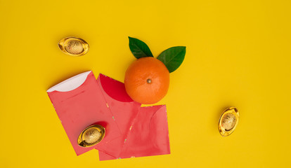 Accessories on Lunar New Year & Chinese New Year vacation concept background.Orange in white plate with red pocket money