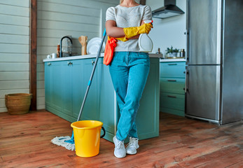 Cleaning concept. Image of an attractive woman in casual clothes and protective gloves with a rag...