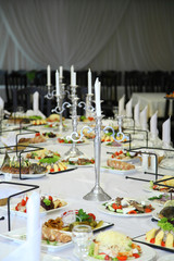 Table setting in a restaurant. Empty glasses set in restaurant. Table setting with glasses, cutlery and plates. Restaurant interior.