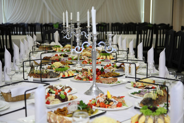 Table setting in a restaurant. Empty glasses set in restaurant. Table setting with glasses, cutlery and plates. Restaurant interior.