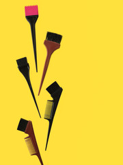 hairstyling tools with dye brush on yellow background