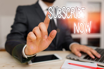 Handwriting text Subscribe Now. Conceptual photo to pay money to an organization in order to receive a service Male human wear formal clothes present presentation use hi tech smartphone