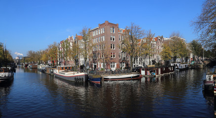 Fototapeta na wymiar Canal with house boats in Amsterdam, Holland