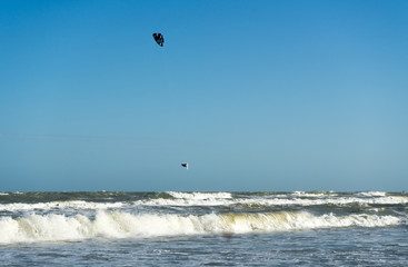 Kitessurfer flying under the sea .A person surfing and parachuting at the same time in Vietnam.