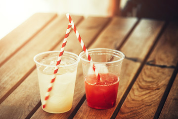 Fresh cold drinks on a wooden table, thirst and impatience