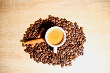 A cup of coffee with heart pattern in a white cup on wooden background