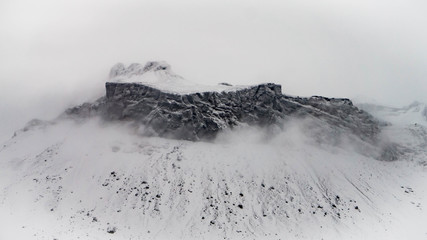 Huge rocky structures on a foggy glacier in Iceland