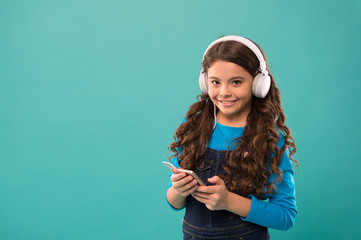 small girl hold mp3 player. choosing favorite song. e-learning in modern life. schoolgirl use new...