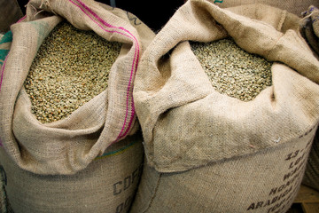 Green coffee beans in a jute bag