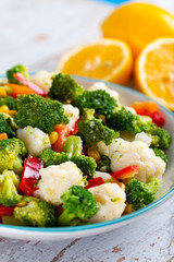Bowl of fresh vegetable salad on wooden background