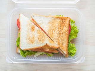 Top view or directly above of sandwich in plastic box, cooking for breakfast, lunch, dinner or...