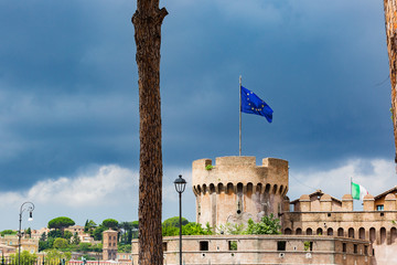 View of Castel Sant' Angelo, Saint Giovanni bastion, EU flag . Cloudy summer day