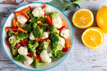 Bowl of fresh vegetable salad on wooden background