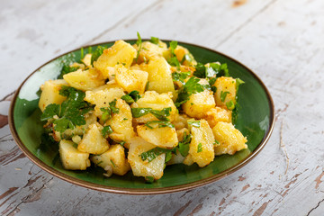 Homemade potatoe salad plate on wooden table