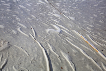 The textured surface of the dense protective fabric covers the drainage system of the city fountain in winter