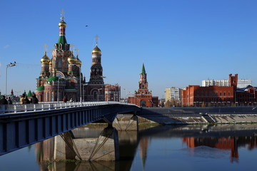Fototapeta premium Cathedral of the Annunciation of the Blessed Virgin Mary. city of Yoshkar-Ola, Mari El Republic, Russia. Buildings are reflected in the water. Architecture of the city of Yoshkar-Ola