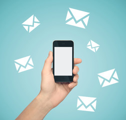 Hand holding smartphone with email symbol