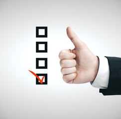 Hand with thumbs up sign and drawing check box.
