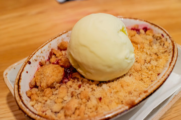 Close up shot of a plate of delicious dessert with ice cream and cookies