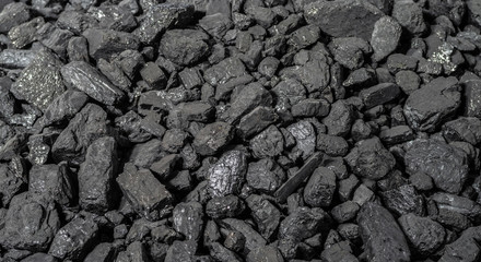 Anthracite is the best type of hard coal. Panoramic background from pieces of anthracite. Selective focus.