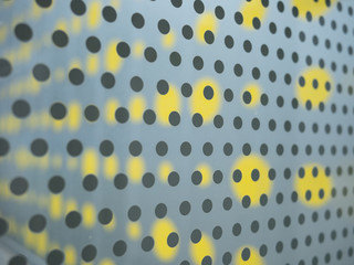 pattern of black and yellow circles on grey wall