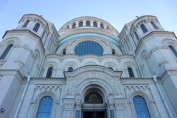 Fototapeta na wymiar View to facade of majestic Naval cathedral of Saint Nicholas in Kronstadt, Russia from below
