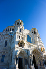 Fototapeta na wymiar Main facade of majestic Naval cathedral of Saint Nicholas in Kronstadt, Russia