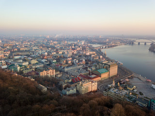 Aerial drone view. View of the Dnieper River and the Podil district in Kiev in the early morning.