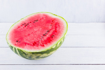 Half of watermelon on white background. Sliced watermelon on wooden boards. Healthy food for vegan. Top view