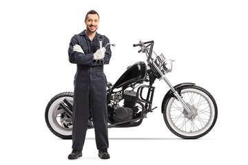 Obraz na płótnie Canvas An auto mechanic standing with a customized motorbike