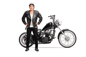 Obraz na płótnie Canvas Biker posing next to a customized chopper motorbike