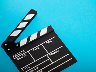 Fototapeta na wymiar Movie production clapper board isolated on blue background. movie clapper isolated on blue. film making production. empty space for text