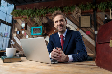 smiling young businessman touching hands in coffeeshop