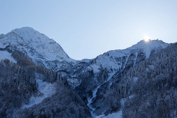 New winter season has began. Snowy mountain peaks landscape. Cloudless sky. Russia, Sochi