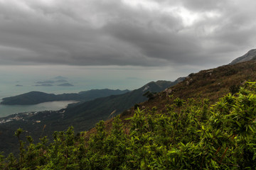 Lantau island is not far from Hong Kong, but the path to Lantau peak is very difficult, especially in winter with wind and fog. The reward for climbing is stunning views from the top of the mountain.