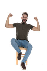 Happy casual man flexing and laughing