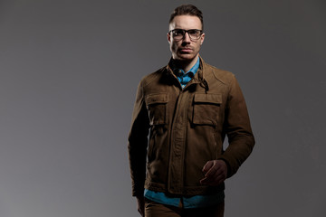 Dramatic fashion model wearing leather jacket and walking