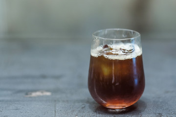 A glass of ice americano coffee in coffee cafe