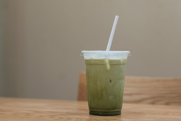 A glass of ice milk green tea in coffee cafe