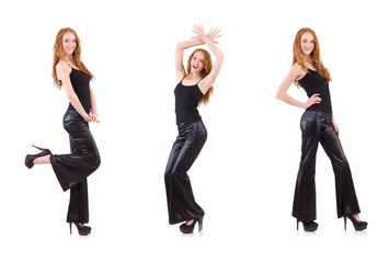 Fototapeta premium Redhead woman in black bell bottom pants on white