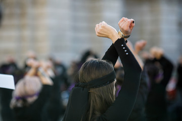 Woman gestures during a feminist flashmob in downtown Bucharest.