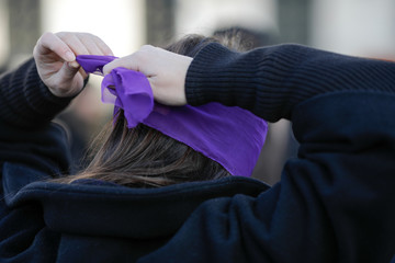 Woman blindfolds herself during a feminist flashmob in downtown Bucharest.