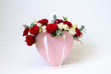 flower arrangement in a pink box on a white background