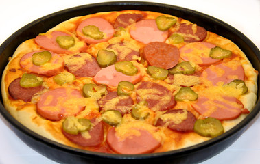  homemade pizza in a pan on white