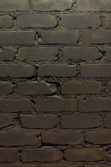 old wall of bricks with cracks