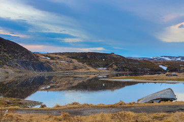 Kola Peninsula, Teriberka: small fishing village with boats, old houses, hilly horizon line-traditional countryside